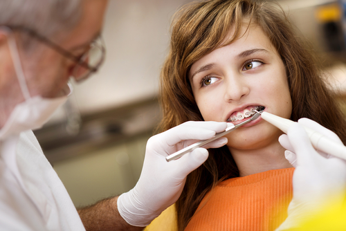 Teenage girl with braces having an orthodontist visit