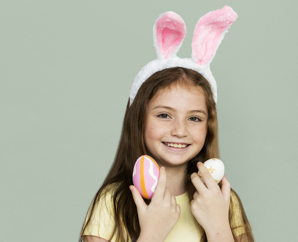 girl in easter bunny headband holding braces friendly easter treats