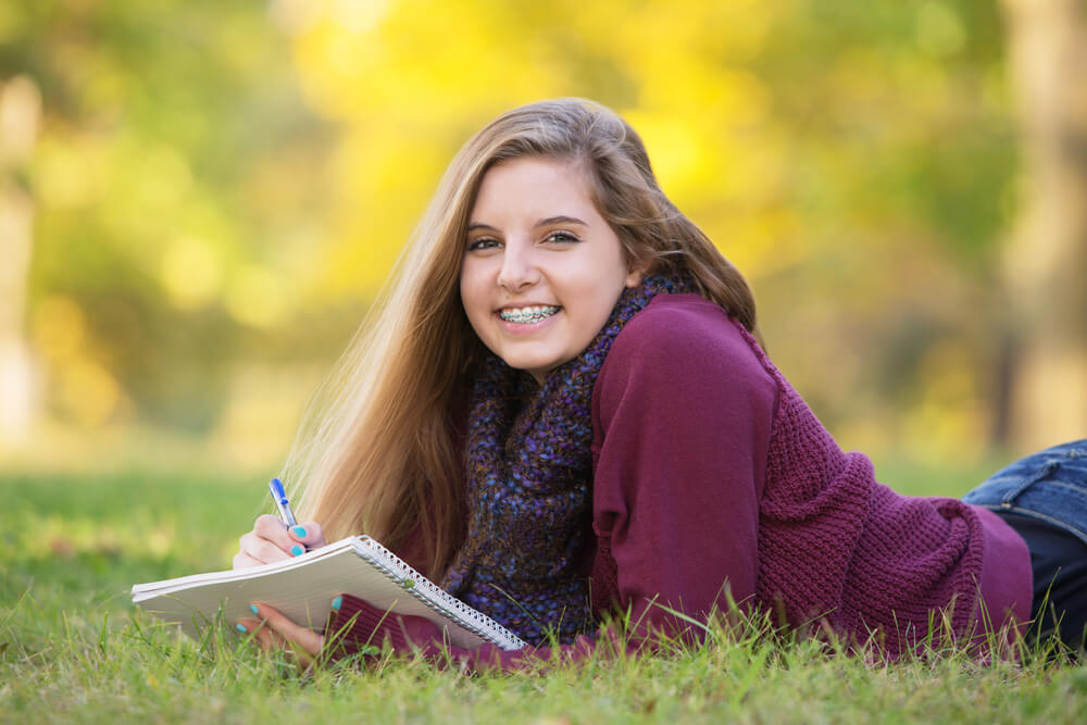 teenager with braces reading