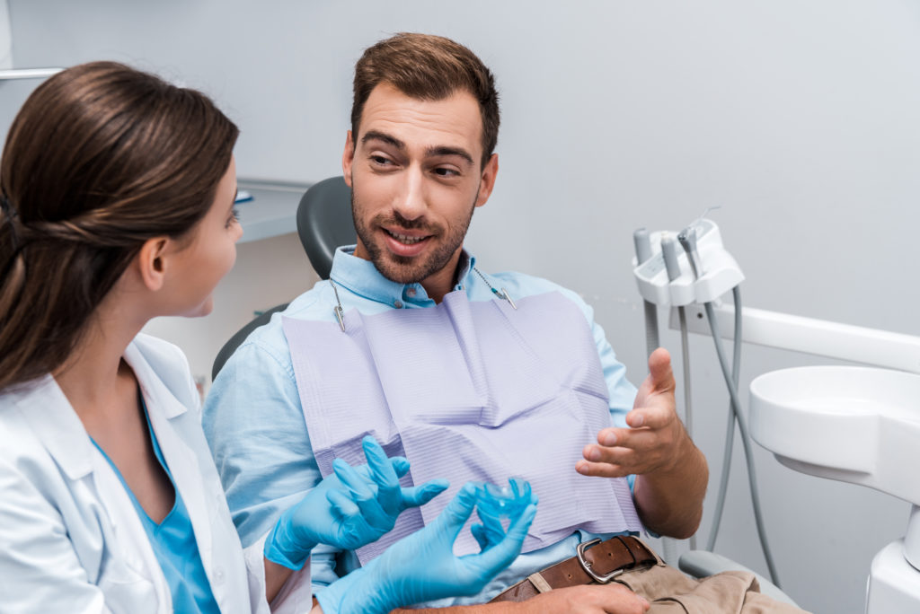 Orthodontist and patient inspecting a retainer