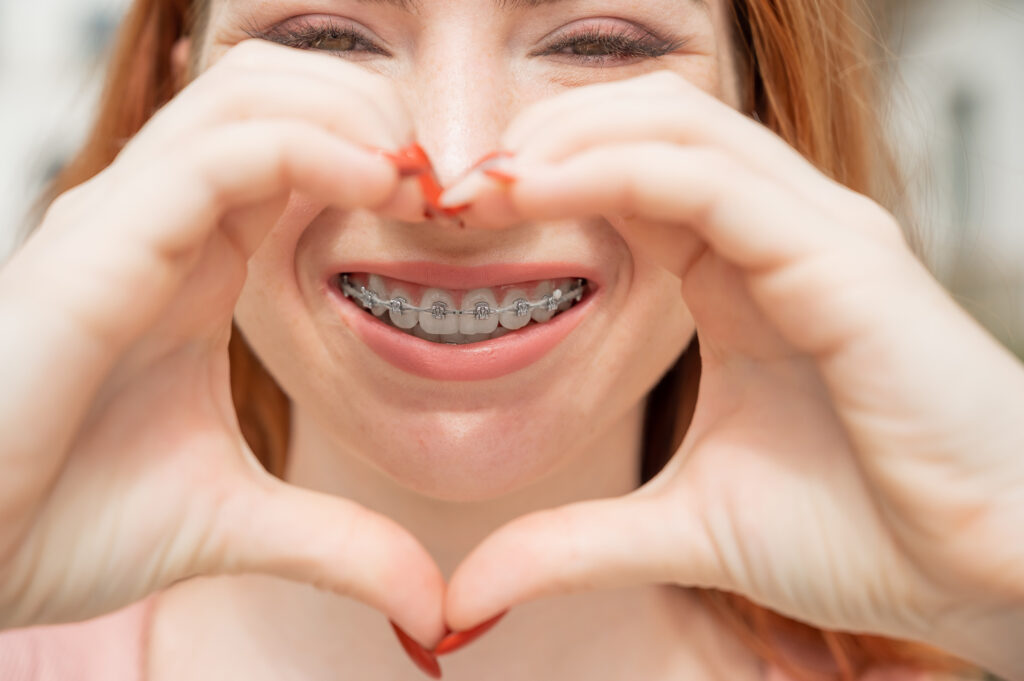 Close up of young woman with braces smiling