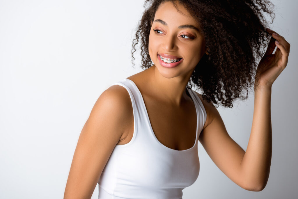 Young woman with braces smiling. 