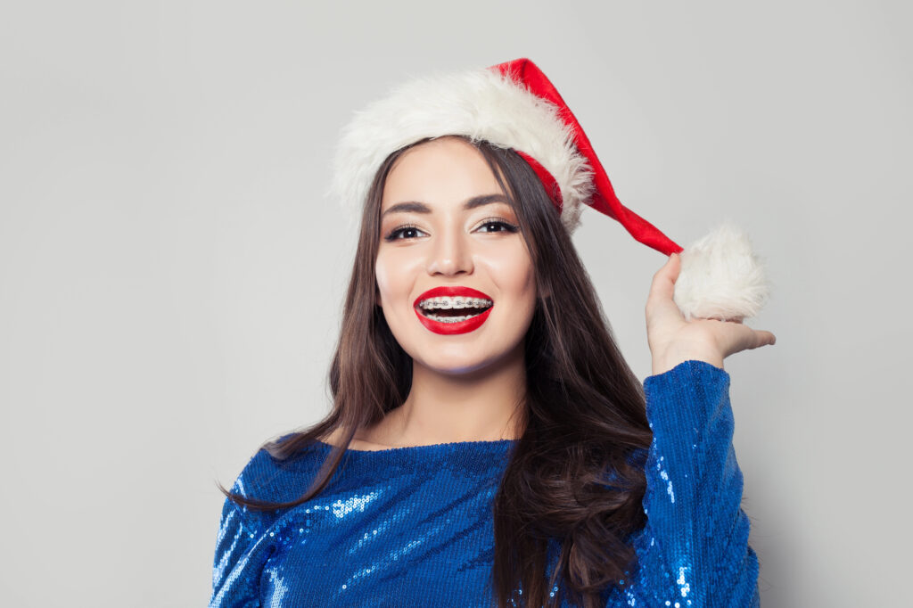 Woman with braces celebrating the holidays.