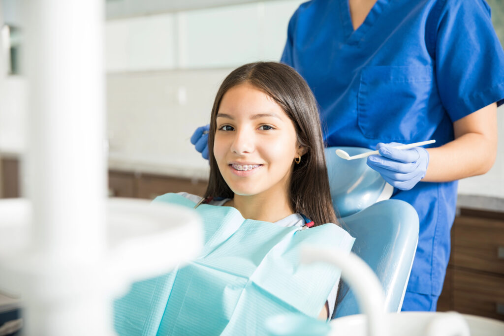 Teen girl at orthodontist appointment to have braces adjusted