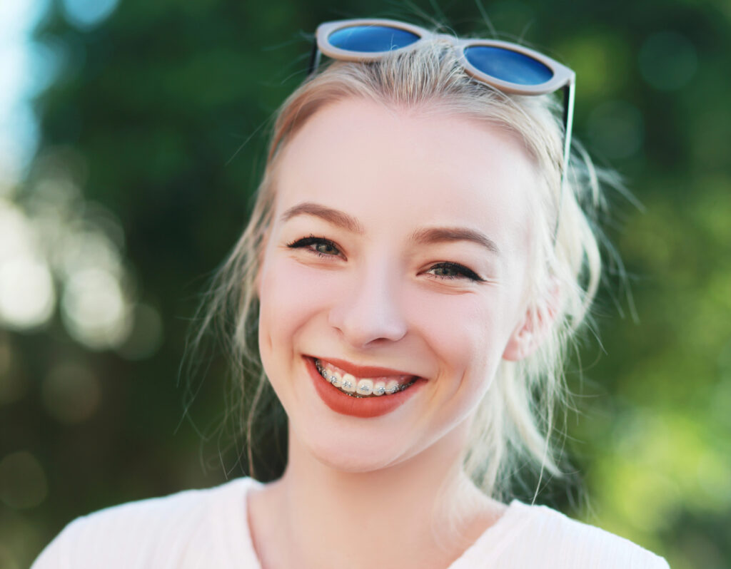 Teen girl with braces enjoying spring outside during allergy season