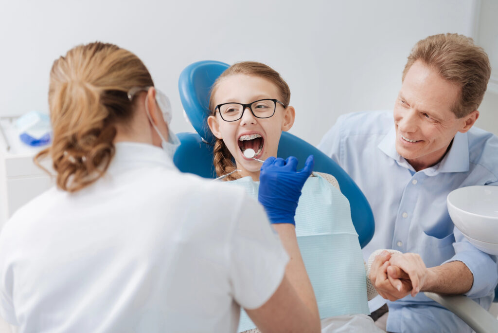 Child and parent at orthodontists office. 