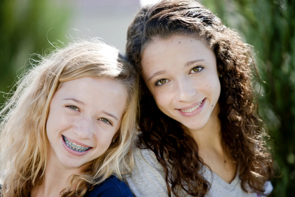 Young girls with braces and aligners
