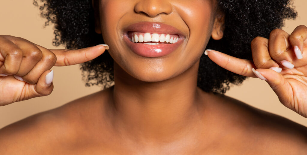 Close-up of woman with healthy, straight teeth after orthodontic treatment