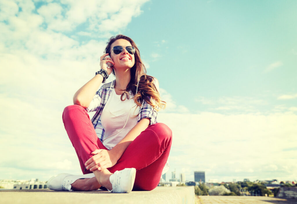 Teen girl with clear aligners smiling in summer. 