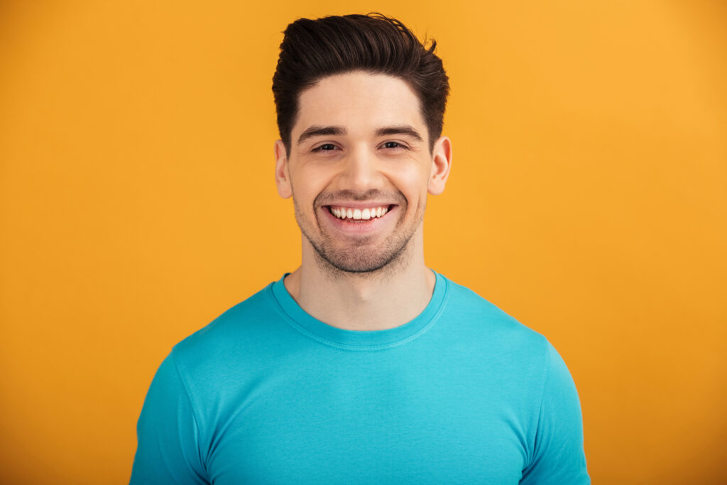 Man with healthy straight teeth smiling. 