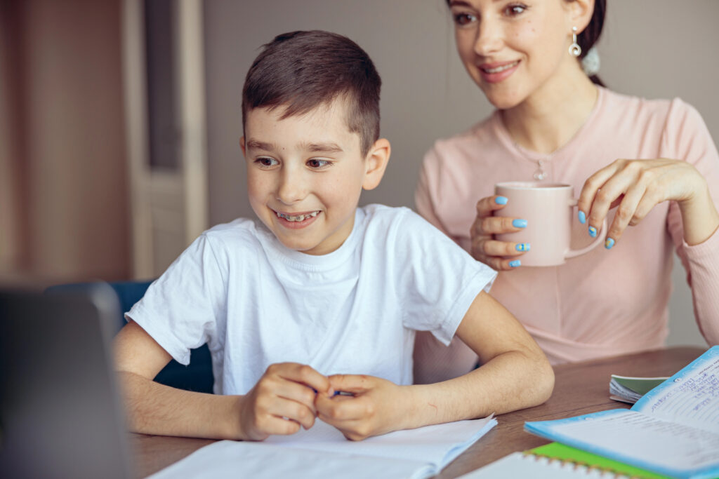 Mother and child with braces looking at a computer. 